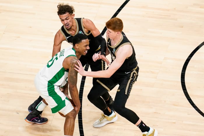 Boston Celtics guard Jeff Teague (55) gets hit in the face by Atlanta Hawks guard Kevin Huerter (3)